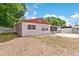 Backyard view of a single-story home with a screened-in porch and fenced yard at 7276 21St Street N, St Petersburg, FL 33702
