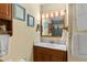 Bathroom featuring a granite vanity, a mirror with lights, and a shower with sliding glass doors at 7276 21St Street N, St Petersburg, FL 33702