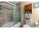 Bathroom featuring a shower with sliding glass doors and a storage cabinet above the toilet at 7276 21St Street N, St Petersburg, FL 33702