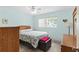 Bright bedroom featuring light blue walls, tile floors, a window and a ceiling fan at 7276 21St Street N, St Petersburg, FL 33702