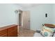 This bedroom features tile floors, light blue walls, and a beach themed decorative pillow on a loveseat at 7276 21St Street N, St Petersburg, FL 33702