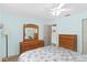 Comfortable bedroom featuring light blue walls, tile floors, and a ceiling fan at 7276 21St Street N, St Petersburg, FL 33702