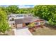 Aerial of the home's exterior with an attached garage, mature landscaping, and well manicured lawn at 7276 21St Street N, St Petersburg, FL 33702