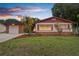 Charming single-story home featuring a well-maintained lawn and colorful landscaping at 7276 21St Street N, St Petersburg, FL 33702