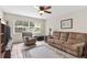Bright living room featuring neutral decor, ceiling fan and a window with natural light at 7276 21St Street N, St Petersburg, FL 33702