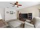 Comfortable living room area with tile flooring, ceiling fan, and cozy seating arrangements at 7276 21St Street N, St Petersburg, FL 33702