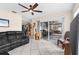 Spacious living room with tile flooring, ceiling fan, and sliding glass doors at 7276 21St Street N, St Petersburg, FL 33702