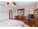 Comfortable main bedroom featuring a ceiling fan, matching wooden furniture and tile flooring at 7276 21St Street N, St Petersburg, FL 33702