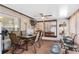 Enclosed patio features tile floors, a ceiling fan, dining table, tv and cushioned chairs at 7276 21St Street N, St Petersburg, FL 33702
