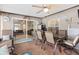 Enclosed patio features tile floors, a ceiling fan, dining table, and cushioned chairs at 7276 21St Street N, St Petersburg, FL 33702