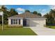 Charming single-story home showcasing stone accents, blue shutters, and a well-manicured lawn at 7670 Wheat Stone Dr, Zephyrhills, FL 33540