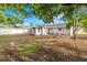 Wide shot of backyard with picnic table and custom landscaping along the house at 7804 Bracken Dr, Port Richey, FL 34668
