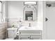 Updated bathroom with modern mirror, updated faucet, new toilet and shower with modern fixtures at 7804 Bracken Dr, Port Richey, FL 34668