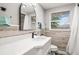 Stylish bathroom with quartz countertop, decorative mirror and modern wood accents at 7804 Bracken Dr, Port Richey, FL 34668
