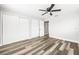 Bedroom featuring wood-look floors, a ceiling fan, and double closets for storage at 7804 Bracken Dr, Port Richey, FL 34668