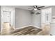 Cozy dining area with hardwood floors and modern ceiling fan, connecting to other rooms at 7804 Bracken Dr, Port Richey, FL 34668