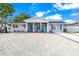 Charming single-story home with a bright blue front door and newly landscaped gravel front yard at 7804 Bracken Dr, Port Richey, FL 34668