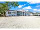 Charming single-story home with a bright blue front door and newly landscaped gravel front yard at 7804 Bracken Dr, Port Richey, FL 34668