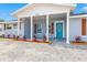 Beautifully updated home with a bright blue front door and quaint front porch at 7804 Bracken Dr, Port Richey, FL 34668