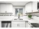 Modern kitchen featuring white cabinets, stainless steel appliances, and a bright window over the sink at 7804 Bracken Dr, Port Richey, FL 34668