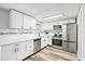 Modern kitchen featuring stainless steel appliances, white cabinets, and stylish subway tile backsplash at 7804 Bracken Dr, Port Richey, FL 34668