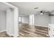 Spacious living room with ceiling fan and modern wood-look flooring throughout the home at 7804 Bracken Dr, Port Richey, FL 34668