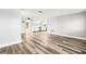 Spacious living area with stylish flooring and white walls, leading to an open-concept kitchen at 7804 Bracken Dr, Port Richey, FL 34668