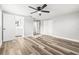Spacious bedroom featuring new floors, gray walls, ceiling fan, large closet, and attached bath at 7804 Bracken Dr, Port Richey, FL 34668