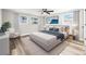 Calm and bright main bedroom with a queen-sized bed, ceiling fan, and bright windows at 7804 Bracken Dr, Port Richey, FL 34668