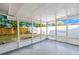 An enclosed back porch offering lots of room with views of the landscaped backyard at 7804 Bracken Dr, Port Richey, FL 34668
