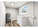 Utility room with newer washer, a dryer and cabinets for additional storage at 7804 Bracken Dr, Port Richey, FL 34668