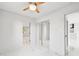 Bright bedroom features pristine white walls, ceiling fan, and sleek marble floors at 7930 Jeffery Ave, North Port, FL 34287