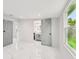 Bright bedroom with ensuite bathroom and double windows with lush exterior views at 7930 Jeffery Ave, North Port, FL 34287