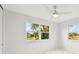 Bedroom featuring lots of light, a ceiling fan, and views of neighborhood at 7930 Jeffery Ave, North Port, FL 34287