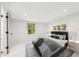 Inviting staged bedroom with natural light, decorative art, and modern furnishings at 7930 Jeffery Ave, North Port, FL 34287