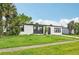 Charming single-story home with a well-manicured lawn and tropical palm trees, perfect for Florida living at 7930 Jeffery Ave, North Port, FL 34287