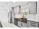 Bright kitchen featuring stainless steel appliances, gray cabinets, and a stainless sink at 7930 Jeffery Ave, North Port, FL 34287