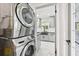 Efficient laundry area showcasing stacked washer and dryer near kitchen at 7930 Jeffery Ave, North Port, FL 34287