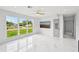 Spacious living room with sleek marble floors, large windows, and a modern ceiling fan at 7930 Jeffery Ave, North Port, FL 34287