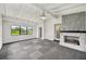 Open living room with fireplace, carpeted floor and natural light at 7930 Jeffery Ave, North Port, FL 34287