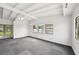 Open living room with vaulted ceiling, carpet and natural light at 7930 Jeffery Ave, North Port, FL 34287