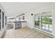 Inviting covered patio featuring tile flooring, a convenient bar area, and sliding glass doors to bring the outdoors in at 7930 Jeffery Ave, North Port, FL 34287