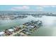 Aerial view of waterfront community with Gulf access, private docks, and stunning skyline views at 820 Bay Point Dr, Madeira Beach, FL 33708