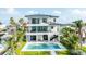 This amazing three-story property has balconies, a pool, and easy water access near beachside communities at 820 Bay Point Dr, Madeira Beach, FL 33708