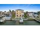 Waterfront home with private dock and a sparkling pool, surrounded by lush landscaping at 820 Bay Point Dr, Madeira Beach, FL 33708