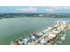 Aerial view of the property in waterfront community with boat docks and incredible water access at 820 Bay Point Dr, Madeira Beach, FL 33708