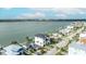 Scenic view of a waterfront home with palm trees, showcasing its ideal coastal location at 820 Bay Point Dr, Madeira Beach, FL 33708