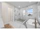 Luxurious bathroom featuring a large glass-enclosed shower, free standing tub, and marble accents at 820 Bay Point Dr, Madeira Beach, FL 33708