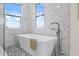Modern bathroom with free-standing tub and patterned tile floor at 820 Bay Point Dr, Madeira Beach, FL 33708