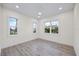 Bright, empty bedroom with hardwood floors, white trim, and plenty of natural light from the windows at 820 Bay Point Dr, Madeira Beach, FL 33708